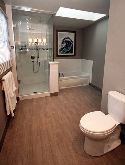 Example of a mid-sized transitional master white tile and subway tile medium tone wood floor and brown floor alcove bathtub design with a two-piece toilet, brown walls and a hinged shower door