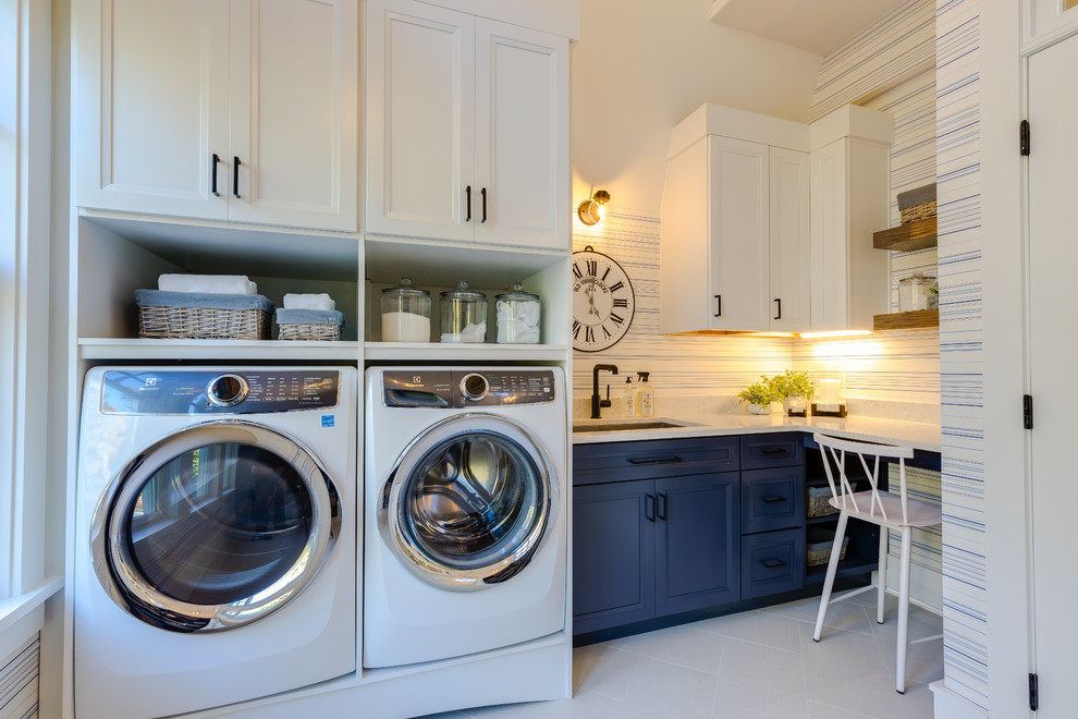 Design ideas for a large modern l-shaped utility room in Other with an undermount sink, shaker cabinets, blue cabinets, quartz benchtops, white walls, porcelain floors, an integrated washer and dryer, white floor and white benchtop.