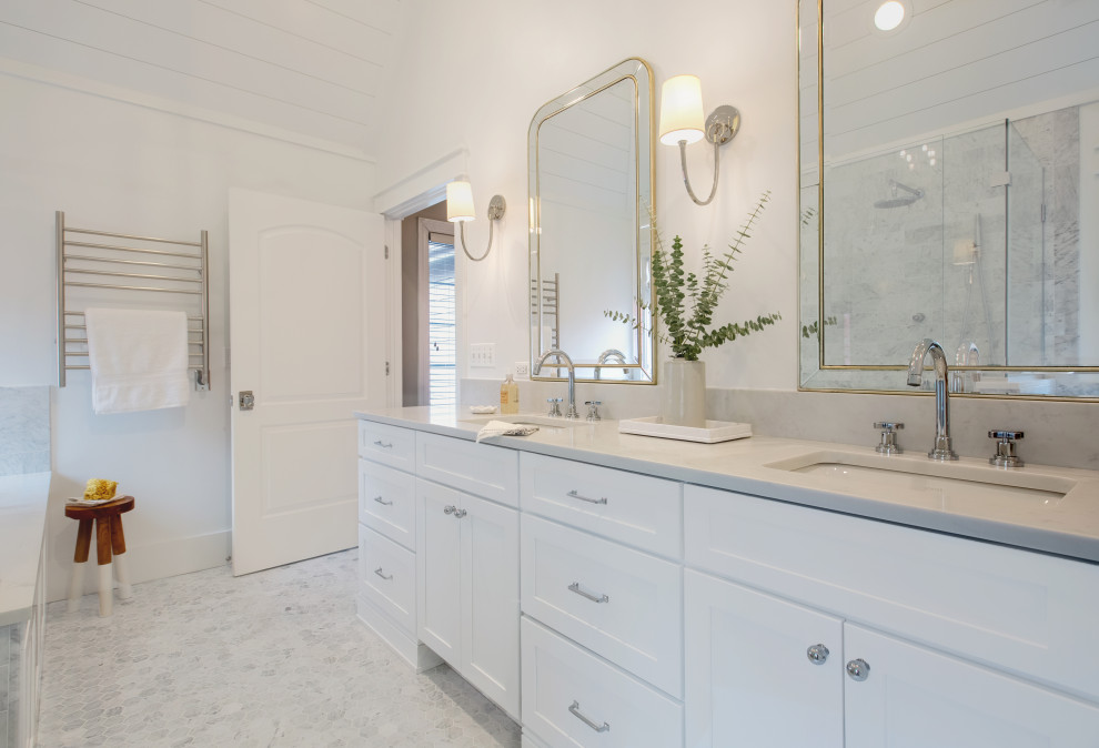 This is an example of a large transitional master bathroom in Chicago with shaker cabinets, white cabinets, an alcove tub, a curbless shower, a one-piece toilet, white walls, marble floors, an undermount sink, quartzite benchtops, grey floor, a hinged shower door, white benchtops, a shower seat, a double vanity, a built-in vanity and timber.