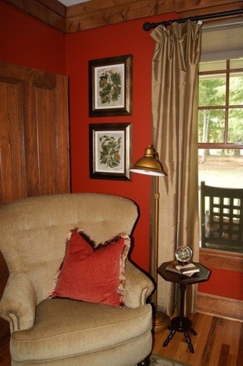 Mid-sized living room in Atlanta with red walls and medium hardwood floors.