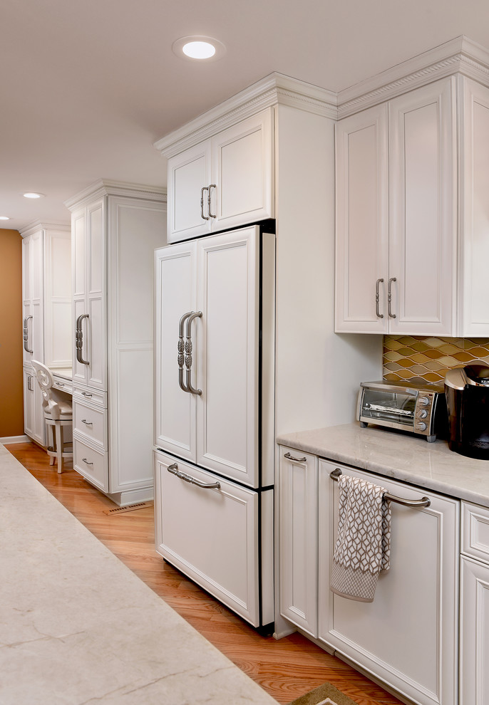 Inspiration for a transitional separate kitchen in Baltimore with recessed-panel cabinets, white cabinets, beige splashback, panelled appliances, light hardwood floors and with island.