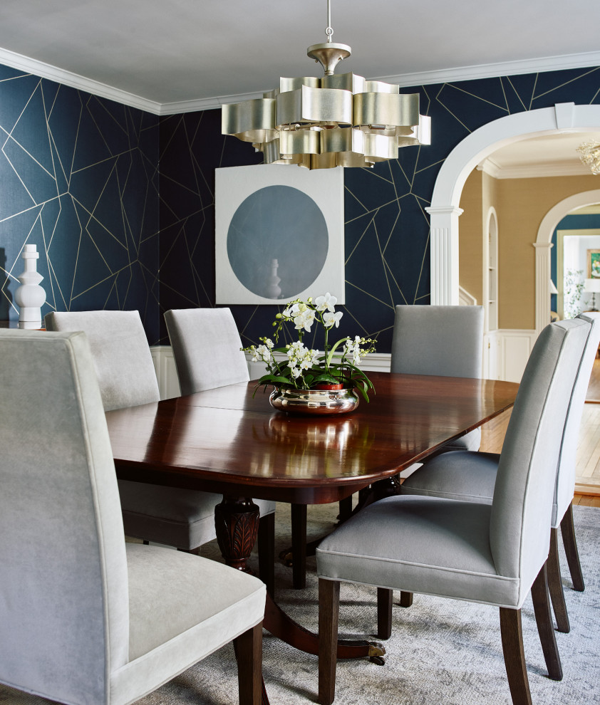 This is an example of a mid-sized transitional separate dining room in Boston with blue walls, medium hardwood floors, no fireplace, brown floor and wallpaper.