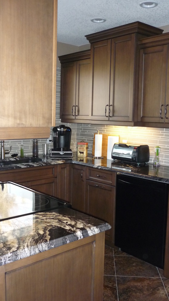 Inspiration for a small transitional u-shaped vinyl floor and brown floor eat-in kitchen remodel in Edmonton with an undermount sink, granite countertops, beige backsplash, glass tile backsplash, black appliances, shaker cabinets, dark wood cabinets and no island