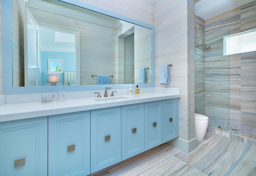 Свежая идея для дизайна: ванная комната в морском стиле с фасадами с утопленной филенкой, синими фасадами, душем в нише, бежевой плиткой, бежевыми стенами, врезной раковиной, бежевым полом, открытым душем, белой столешницей, тумбой под одну раковину, подвесной тумбой и обоями на стенах - отличное фото интерьера