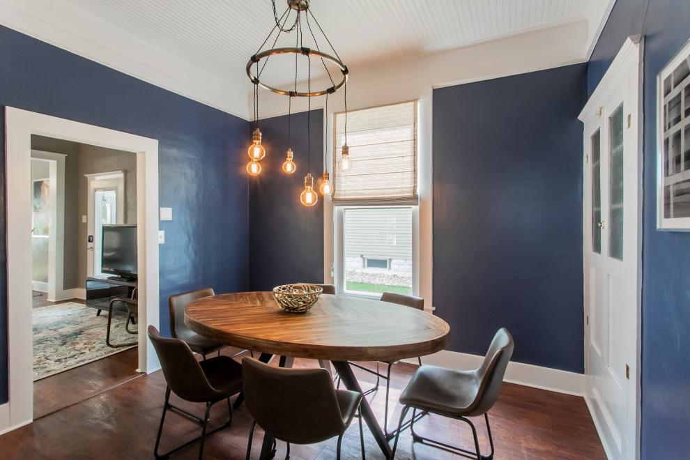 Design ideas for a small eclectic separate dining room in Chicago with blue walls and laminate floors.