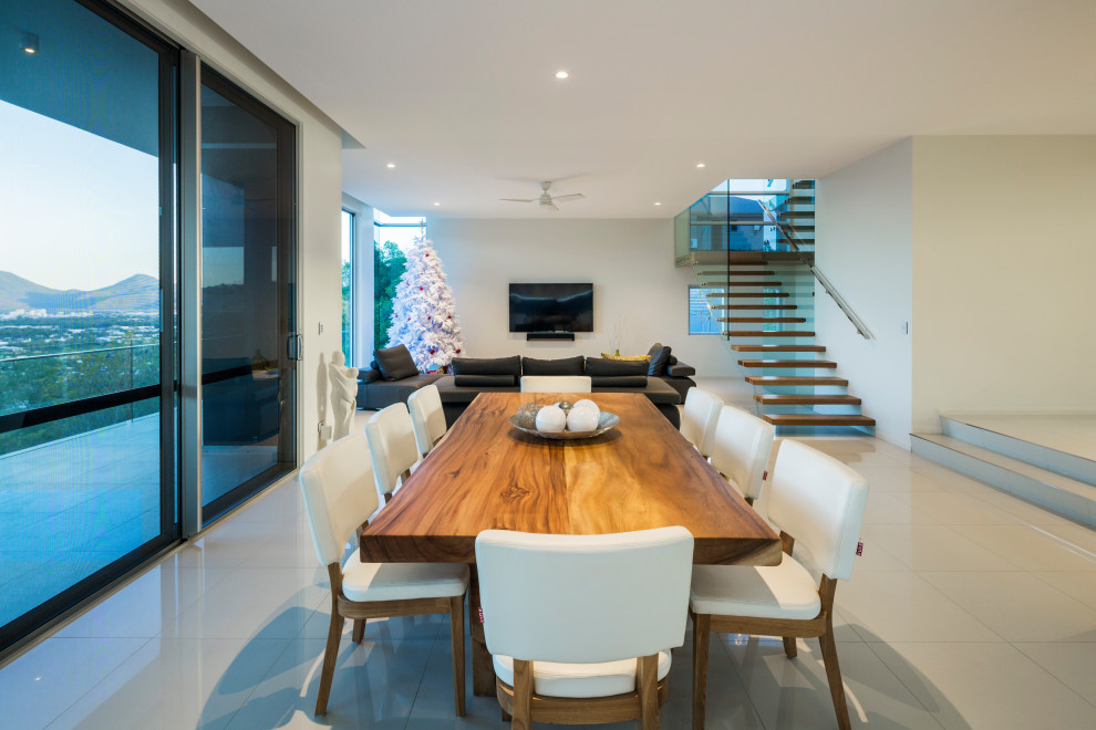 Inspiration for a contemporary dining room in Cairns with porcelain floors and white floor.