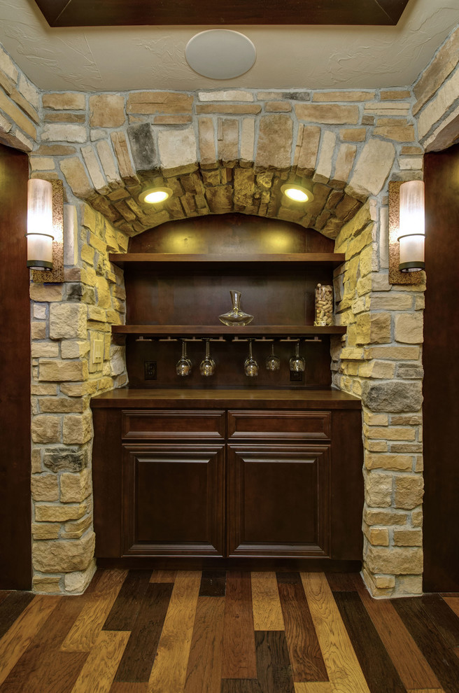 Design ideas for a mid-sized traditional wine cellar in Denver with dark hardwood floors, display racks and multi-coloured floor.