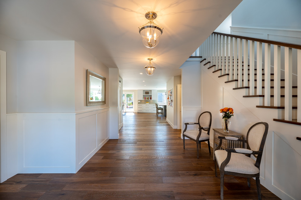 Photo of an expansive transitional foyer in Los Angeles with medium hardwood floors and brown floor.