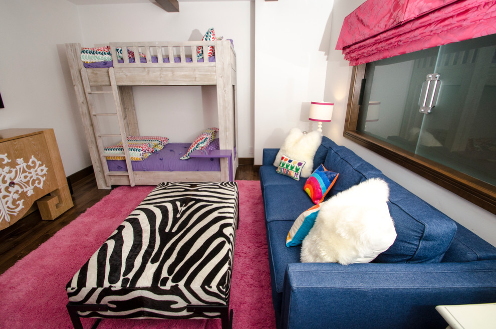This is an example of a transitional kids' room in Denver with white walls and medium hardwood floors.
