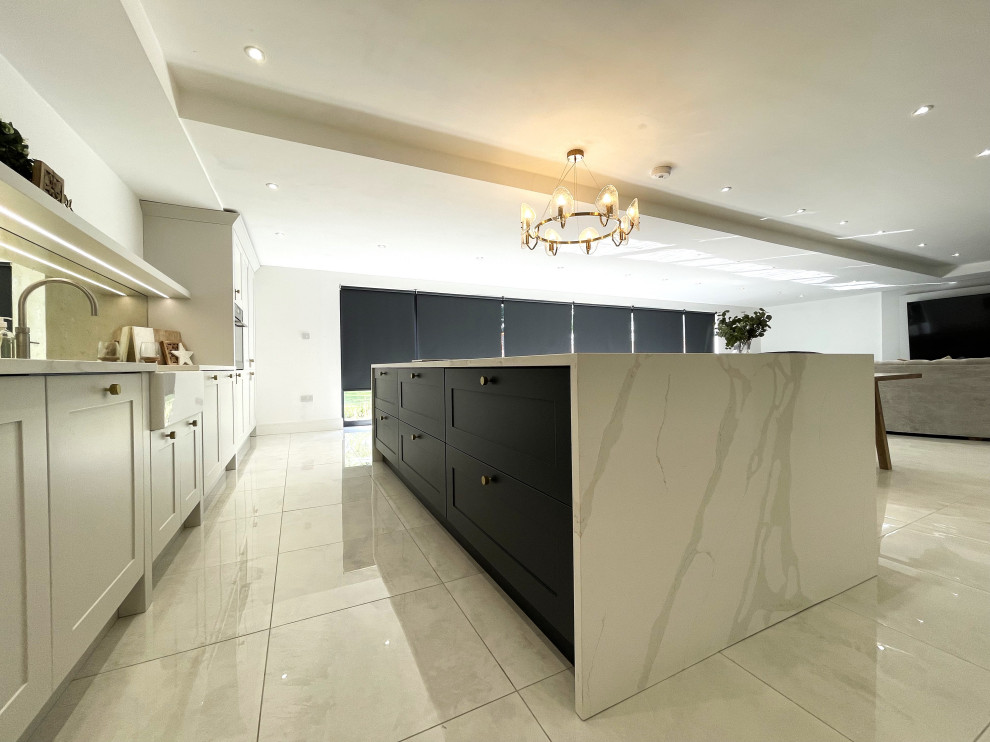 Inspiration for a large traditional single-wall open plan kitchen in Other with a belfast sink, shaker cabinets, medium wood cabinets, engineered stone countertops, glass sheet splashback, black appliances, porcelain flooring and an island.