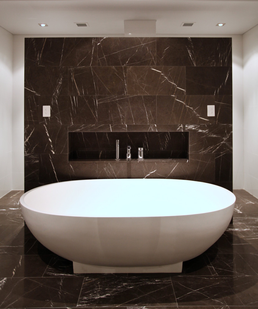 Example of a transitional black tile, black and white tile and white tile freestanding bathtub design in Perth with flat-panel cabinets, white walls and an integrated sink