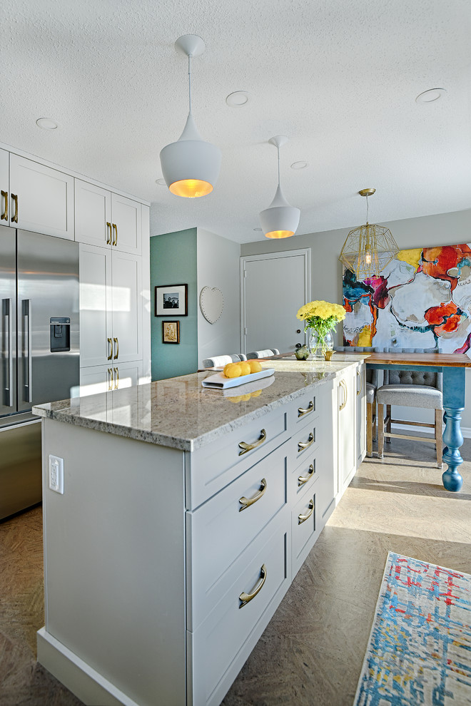 Example of a mid-sized transitional cork floor enclosed kitchen design in Ottawa with an undermount sink, shaker cabinets, white cabinets, granite countertops, gray backsplash, ceramic backsplash, stainless steel appliances and an island