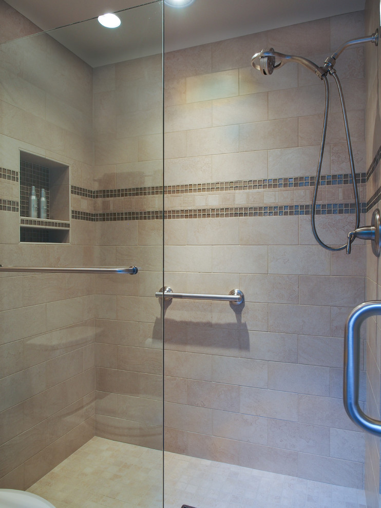 This is an example of a large traditional master bathroom in Seattle with a drop-in sink, raised-panel cabinets, white cabinets, engineered quartz benchtops, a drop-in tub, an alcove shower, a two-piece toilet, beige tile, porcelain tile, white walls, porcelain floors, beige floor, a sliding shower screen, multi-coloured benchtops, a double vanity, a built-in vanity and recessed.