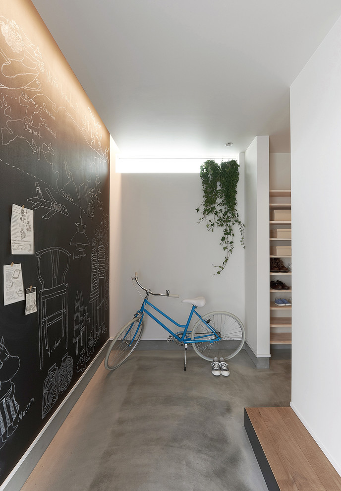 Photo of a scandinavian entryway in Other with grey floor.