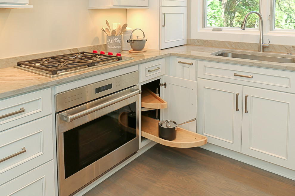Small transitional galley light wood floor eat-in kitchen photo in Chicago with an undermount sink, recessed-panel cabinets, white cabinets, quartzite countertops, gray backsplash, stone slab backsplash, stainless steel appliances and a peninsula