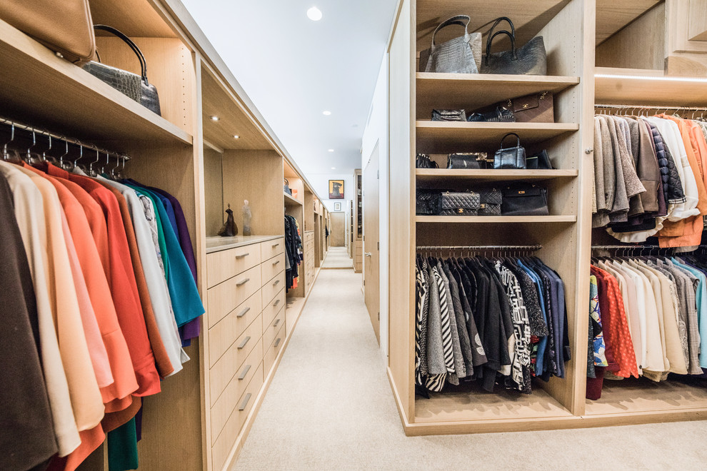 Large contemporary gender-neutral walk-in wardrobe in Dallas with flat-panel cabinets, light wood cabinets, carpet and beige floor.