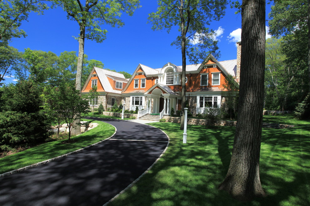 Photo of a large traditional front yard partial sun driveway in Boston with a garden path and natural stone pavers.