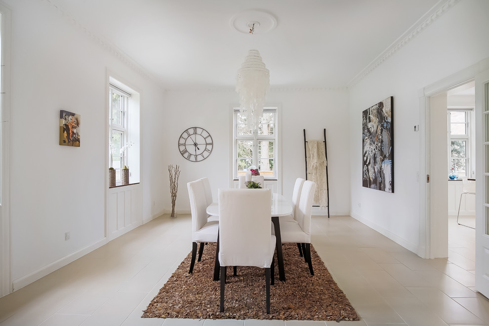 This is an example of a large contemporary separate dining room in Copenhagen with white walls, ceramic floors and no fireplace.