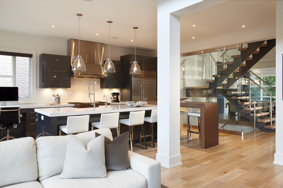 Open concept kitchen - mid-sized modern l-shaped light wood floor open concept kitchen idea in Toronto with a farmhouse sink, flat-panel cabinets, dark wood cabinets, stainless steel appliances and two islands