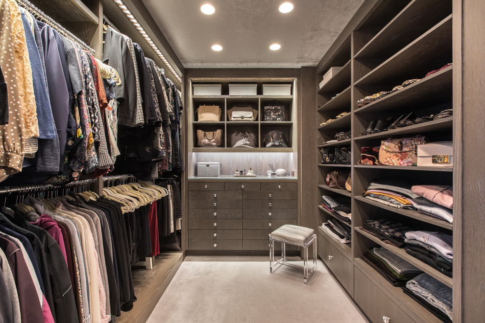 Photo of a contemporary women's walk-in wardrobe in New York with flat-panel cabinets, grey cabinets, carpet and grey floor.