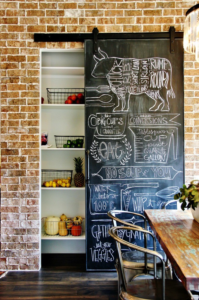 Transitional l-shaped dark wood floor eat-in kitchen photo in Nashville with a farmhouse sink, marble countertops, white backsplash, subway tile backsplash, stainless steel appliances and an island