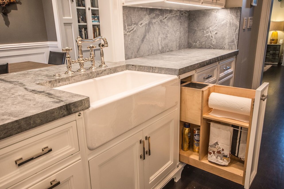 Eat-in kitchen - mid-sized transitional u-shaped dark wood floor eat-in kitchen idea in Chicago with a farmhouse sink, recessed-panel cabinets, white cabinets, quartzite countertops, stone slab backsplash, stainless steel appliances, gray backsplash and a peninsula