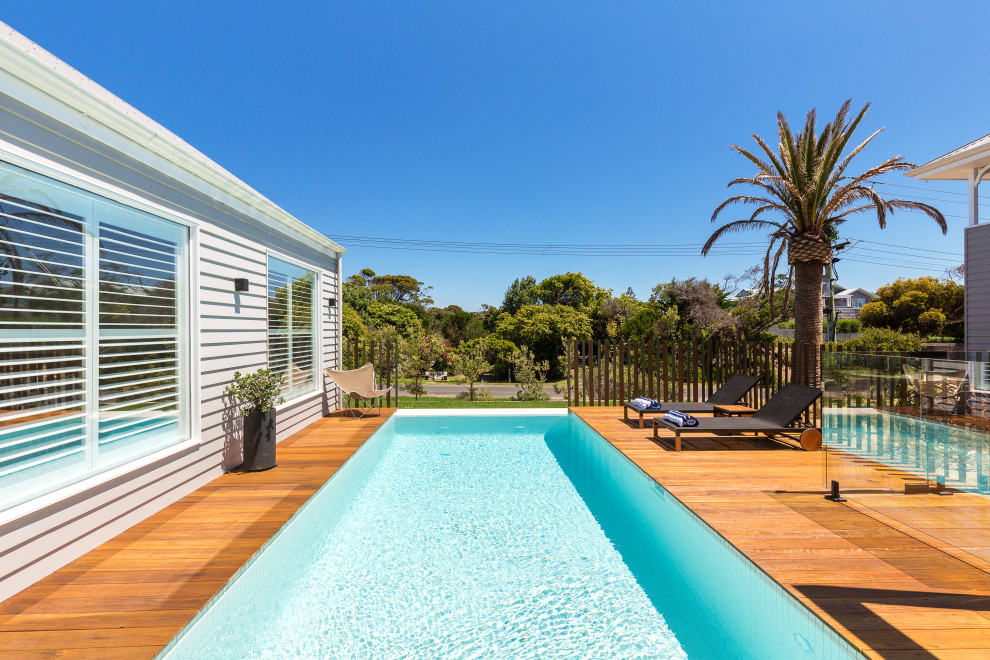 Inspiration for a beach style rectangular pool in Melbourne with decking.