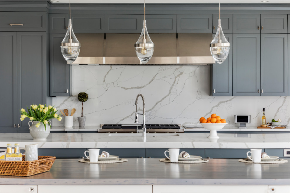Design ideas for an expansive country separate kitchen in Boston with a farmhouse sink, recessed-panel cabinets, grey cabinets, quartzite benchtops, white splashback, marble splashback, stainless steel appliances, light hardwood floors, multiple islands and white benchtop.