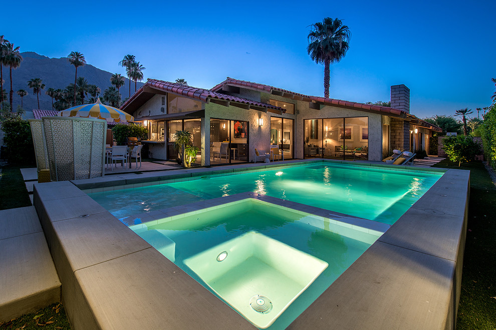 Inspiration for a small midcentury backyard rectangular pool in Los Angeles with a water feature and concrete slab.