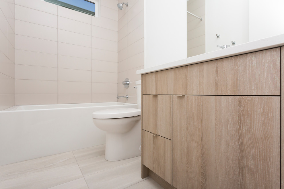 Small contemporary 3/4 bathroom with flat-panel cabinets, brown cabinets, an alcove tub, a shower/bathtub combo, a one-piece toilet, white tile, porcelain tile, white walls, porcelain floors, an undermount sink, solid surface benchtops, beige floor and a shower curtain.
