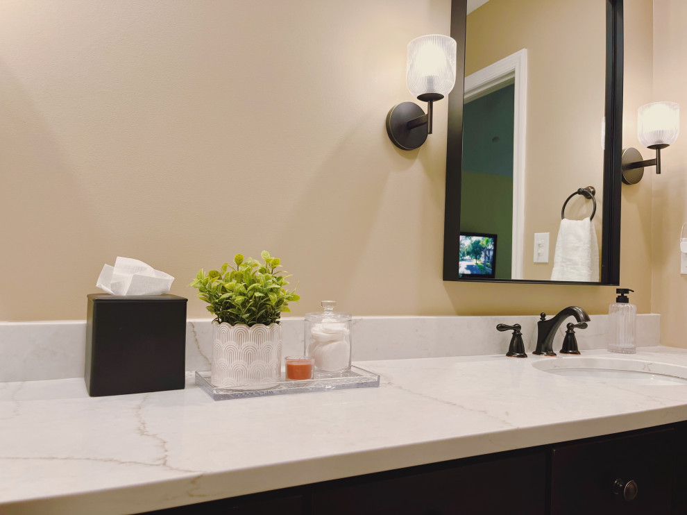 Example of a mid-sized transitional master ceramic tile porcelain tile, beige floor and double-sink alcove shower design with shaker cabinets, dark wood cabinets, a two-piece toilet, beige walls, an undermount sink, quartz countertops, beige countertops and a built-in vanity