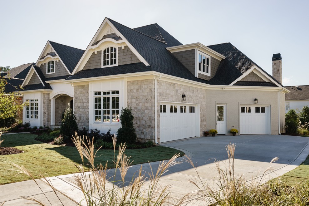 Design ideas for a traditional two-storey beige exterior in Raleigh with mixed siding and a hip roof.