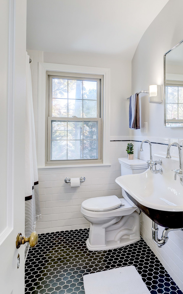 Photo of a small traditional 3/4 bathroom in Baltimore with a two-piece toilet, grey walls, ceramic floors, a trough sink, black floor and a shower curtain.