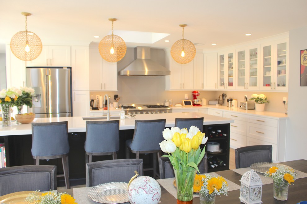 Large transitional l-shaped ceramic tile and beige floor open concept kitchen photo in Phoenix with an undermount sink, shaker cabinets, white cabinets, quartzite countertops, gray backsplash, stainless steel appliances and an island