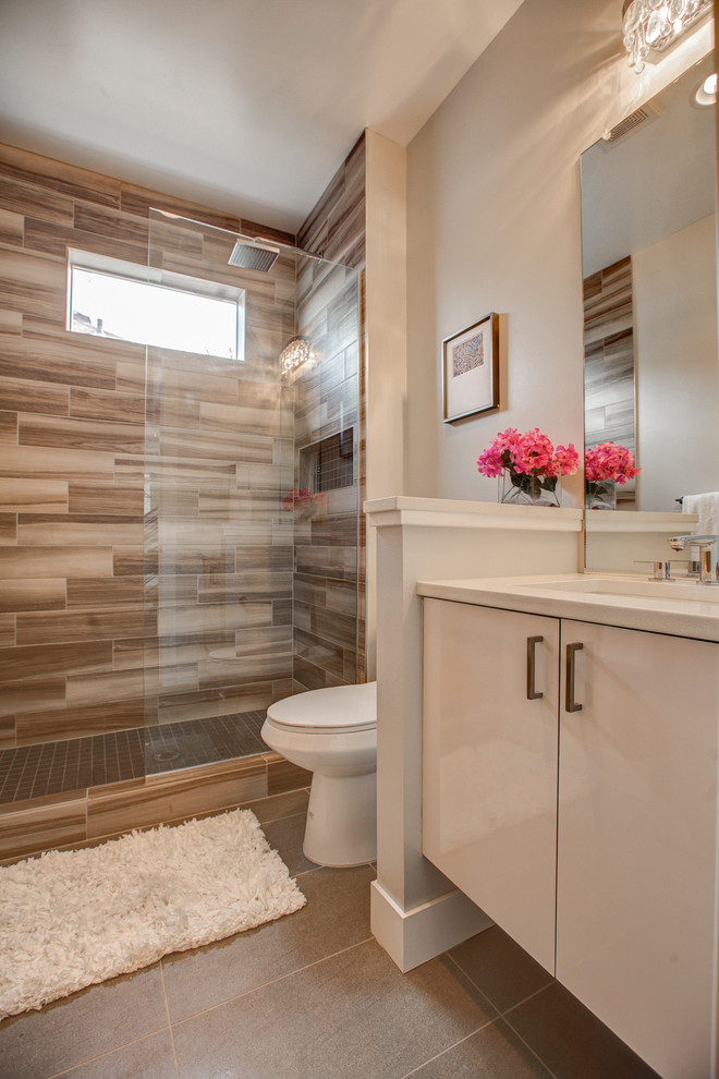 Design ideas for a modern bathroom in Denver with flat-panel cabinets, white cabinets, quartzite benchtops, a one-piece toilet and ceramic tile.