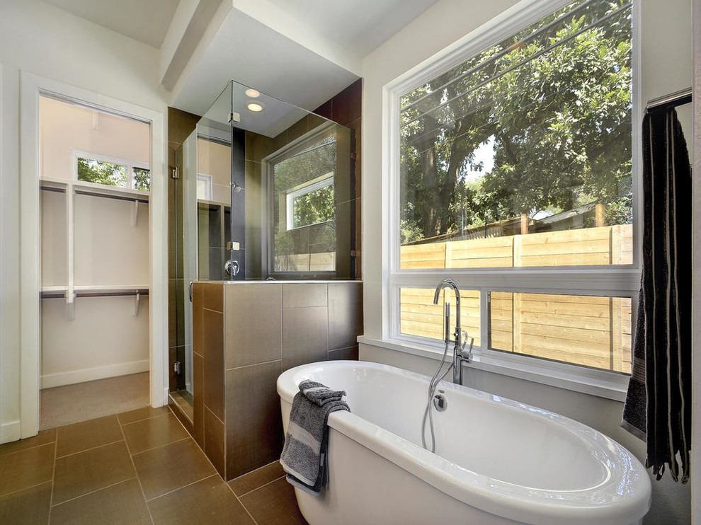Mid-sized contemporary master bathroom in Austin with flat-panel cabinets, dark wood cabinets, a freestanding tub, a corner shower, brown tile, porcelain tile, white walls, porcelain floors, an undermount sink, engineered quartz benchtops, brown floor, a hinged shower door and white benchtops.