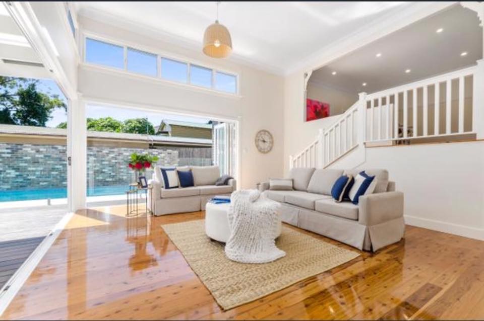 Inspiration for a contemporary living room in Wollongong with white walls, medium hardwood floors and a freestanding tv.