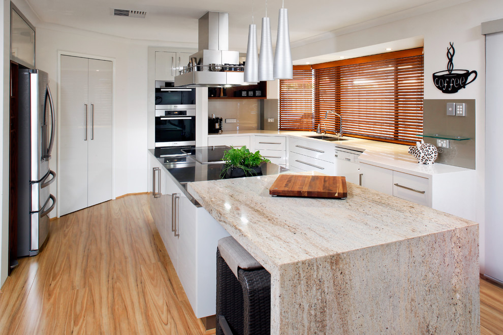 Photo of a contemporary kitchen in Perth with flat-panel cabinets, white cabinets, brown splashback, glass sheet splashback, stainless steel appliances, an undermount sink and granite benchtops.