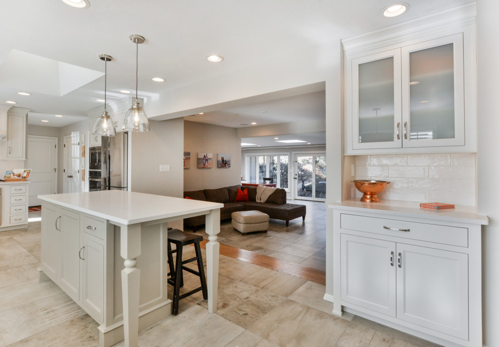 Kitchen - transitional kitchen idea with white cabinets and an island