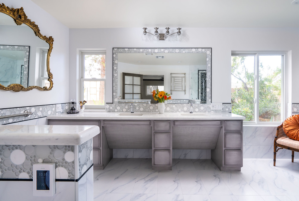 This is an example of a large modern master bathroom in Los Angeles with raised-panel cabinets, grey cabinets, an open shower, a one-piece toilet, white tile, ceramic tile, white walls, ceramic floors, an undermount sink, engineered quartz benchtops, white floor, an open shower and white benchtops.