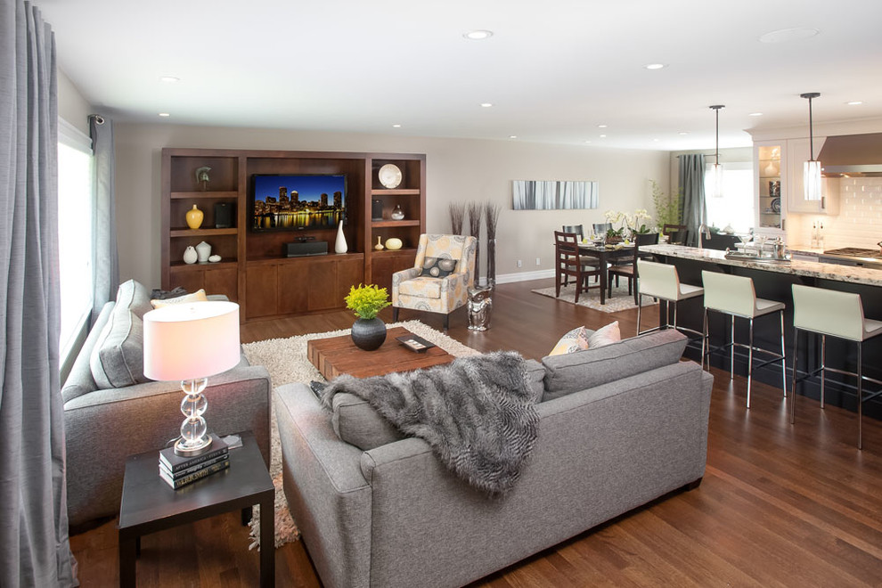 This is an example of a mid-sized transitional open concept living room in Vancouver with beige walls, no fireplace and a built-in media wall.