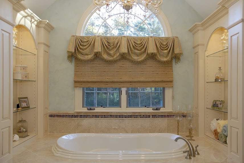 Inspiration for a mid-sized traditional master bathroom in Boston with raised-panel cabinets, beige cabinets, a drop-in tub, blue walls, travertine floors, an undermount sink, granite benchtops and beige floor.