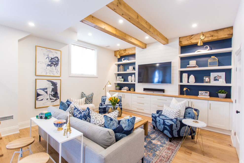 Inspiration for a coastal living room in Toronto With White Walls and Light Hardwood Floors.