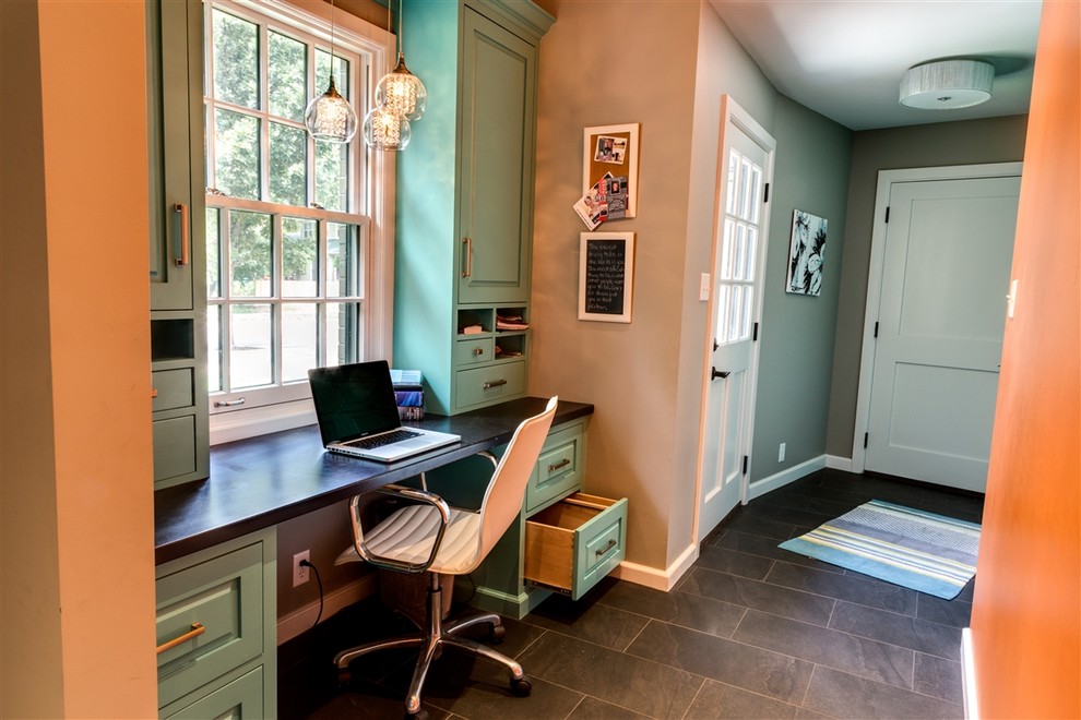 Small transitional study room in Wichita with grey walls, a built-in desk, slate floors, no fireplace and brown floor.