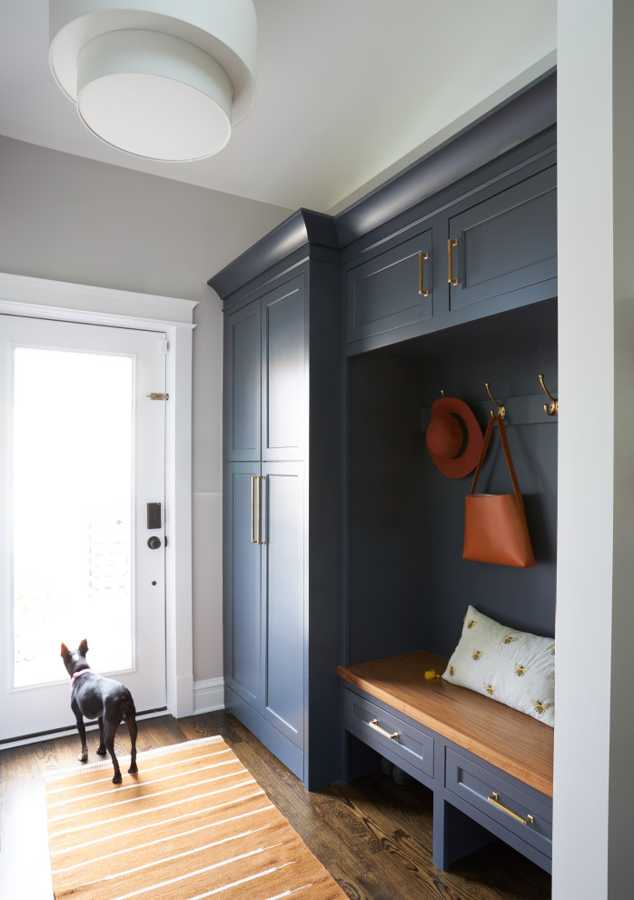 Inspiration for a mid-sized transitional mudroom in Chicago with white walls, medium hardwood floors, a single front door, a white front door and brown floor.