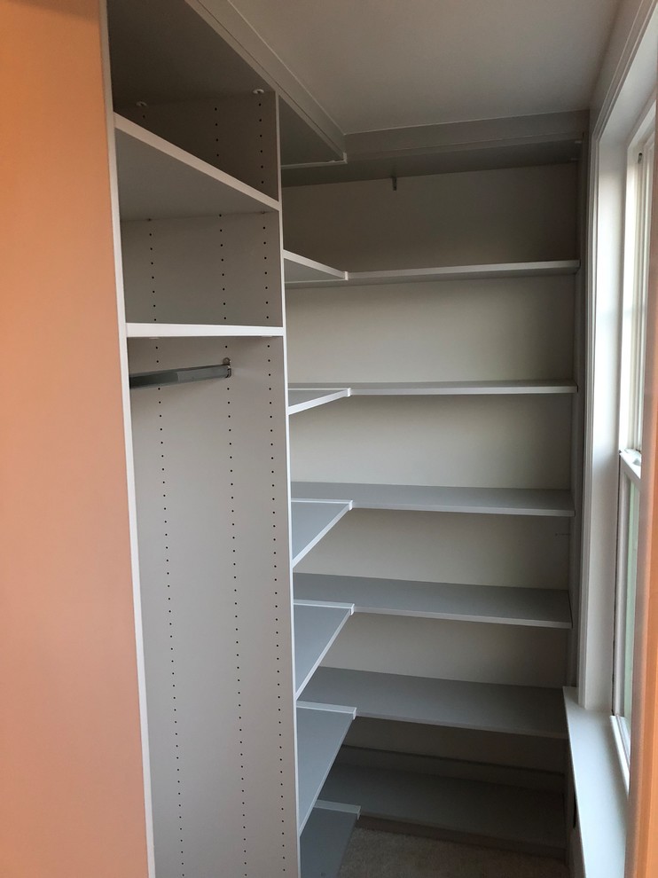 Inspiration for a mid-sized transitional gender-neutral walk-in wardrobe in DC Metro with open cabinets and grey cabinets.