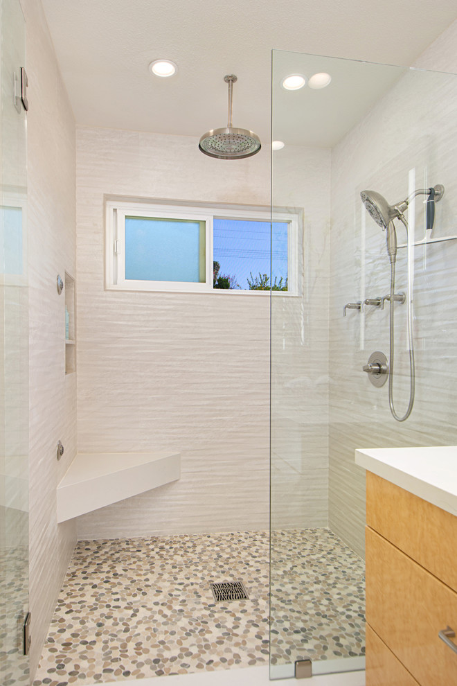 Photo of a mid-sized transitional master bathroom in San Diego with flat-panel cabinets, light wood cabinets, an alcove shower, white tile, porcelain tile, white walls, porcelain floors, an undermount sink, engineered quartz benchtops, beige floor, a hinged shower door and white benchtops.