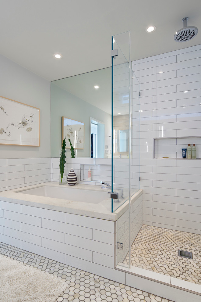 This is an example of a large midcentury master bathroom in San Francisco with an undermount tub, a corner shower, white tile, subway tile, grey walls and marble floors.