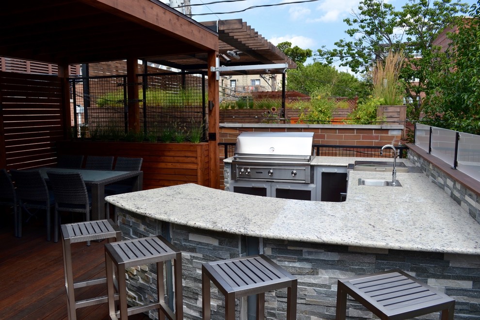 Mid-sized modern rooftop deck in Chicago with an outdoor kitchen and an awning.