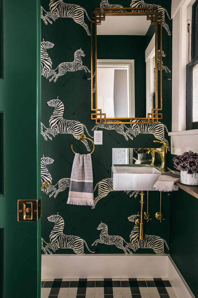 Small transitional powder room in San Francisco with green walls, cement tiles, a wall-mount sink and white floor.